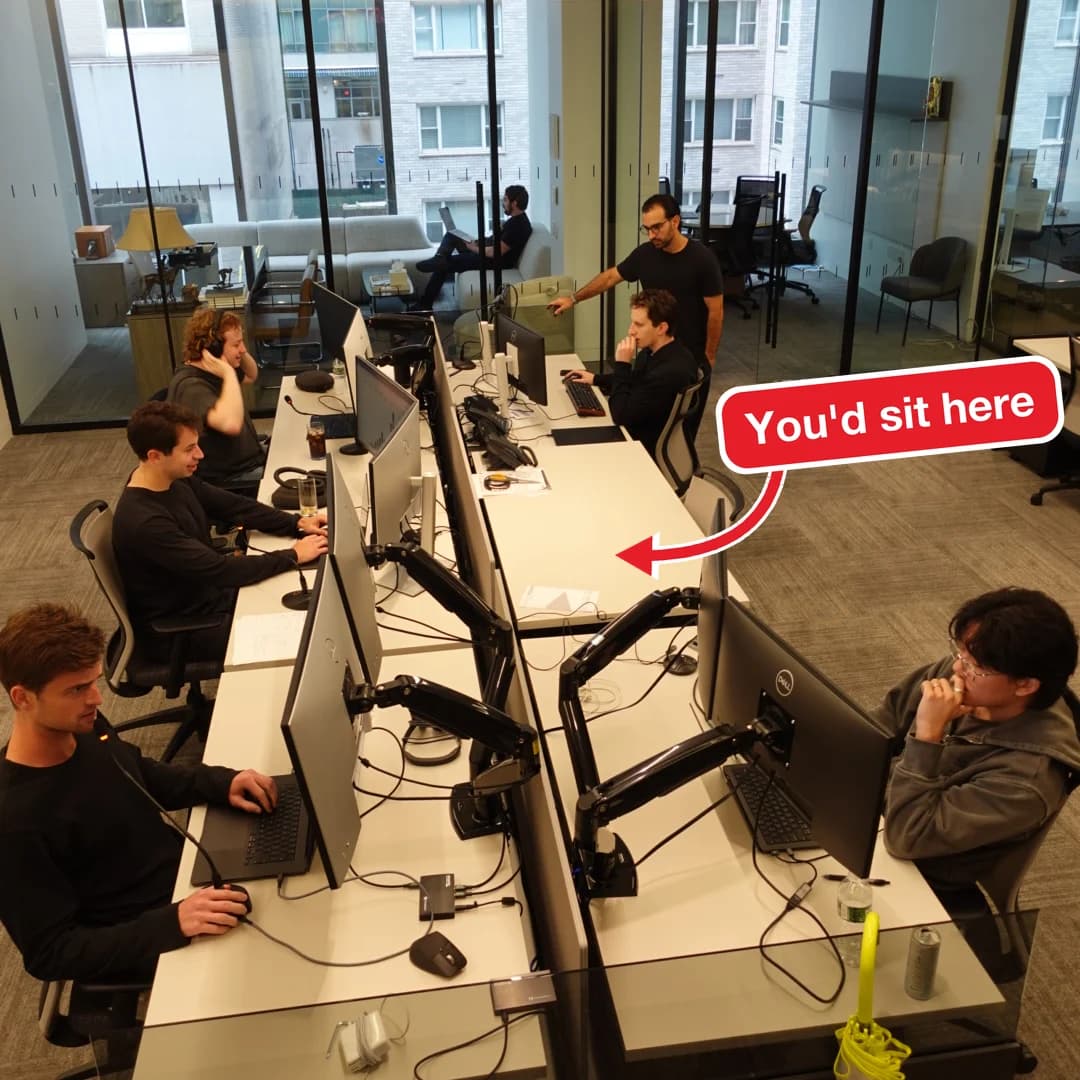 The Spring engineering team at their desks in the New York office, with an arrow marking an empty desk labelled "You'd sit here"